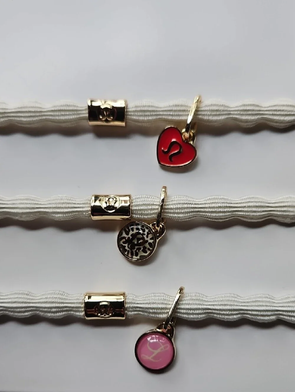 lululemon athletica Charm Hair Ties Trio — White Bands with Red & Pink Charms